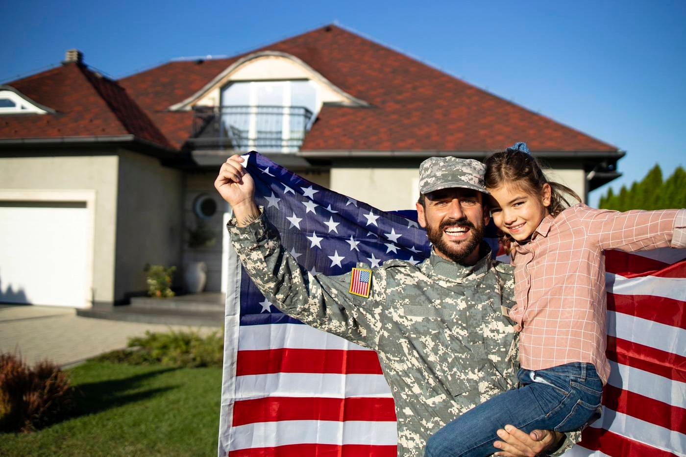 Veteran and spouse smiling outside their new Colorado home.