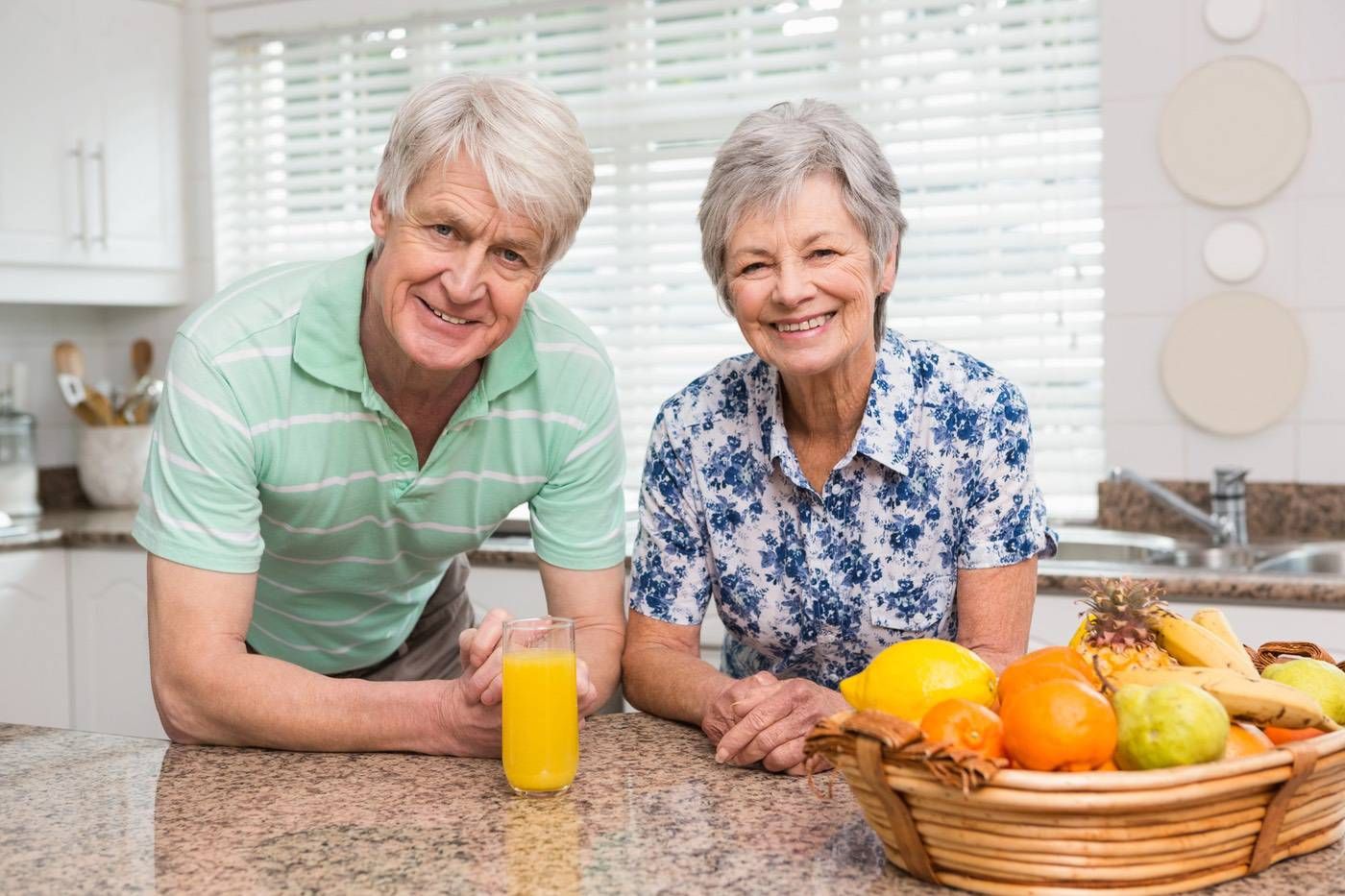 Senior couple relaxing together in a bright living room.