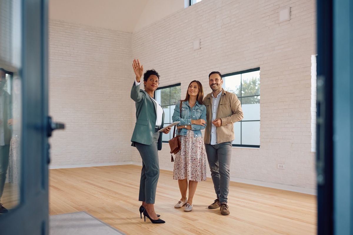 Real estate agent guiding clients through a Colorado home showing.