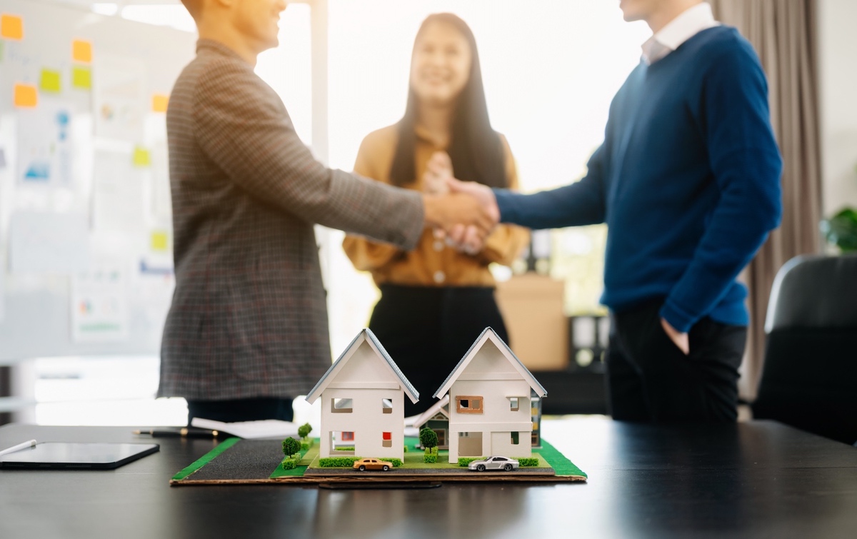 Borrowers reviewing documents in a modern condominium office.