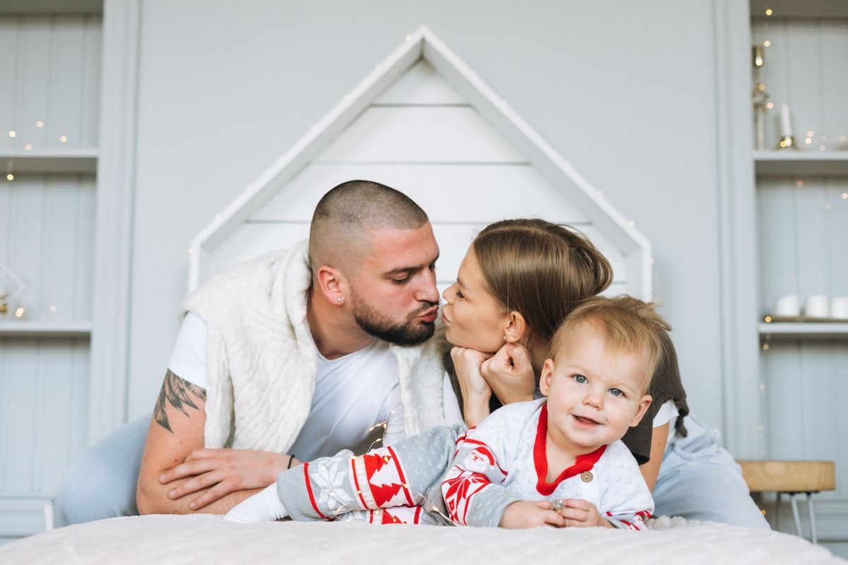 Young family relaxing together on a bright living room sofa.